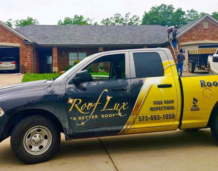Roof Lux company truck parked in front of a house getting a new roof in Lake Ozark MO